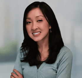 A woman with long black hair and a blue shirt.