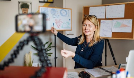 A woman is sitting at her desk and smiling.